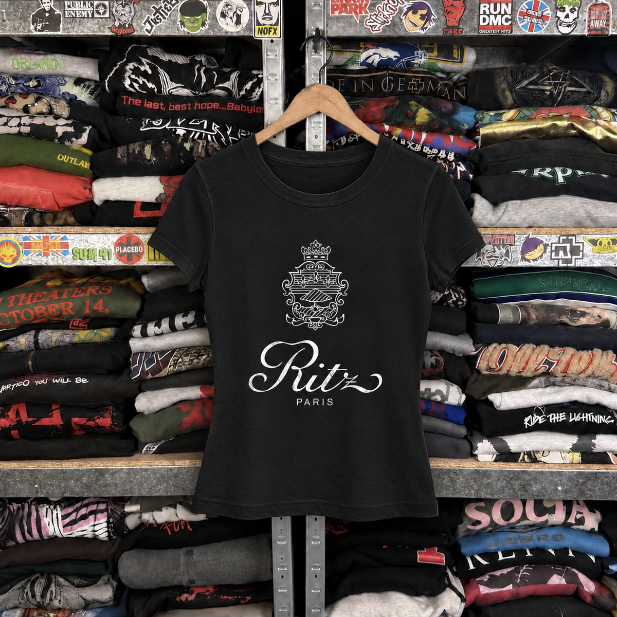 90's Ritz Paris Womens Black Tee — off-body front on wooden hanger