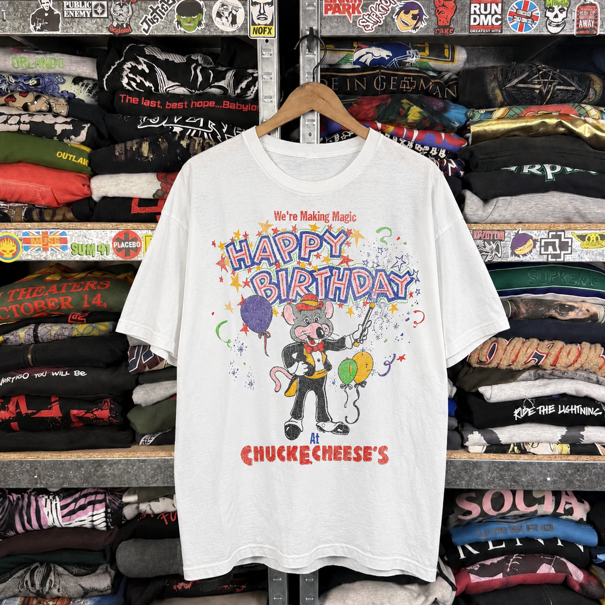 90s Chuck-E-Cheese Birthday Celebration Grail Rare Washed White T-Shirt — off-body front on wooden hanger