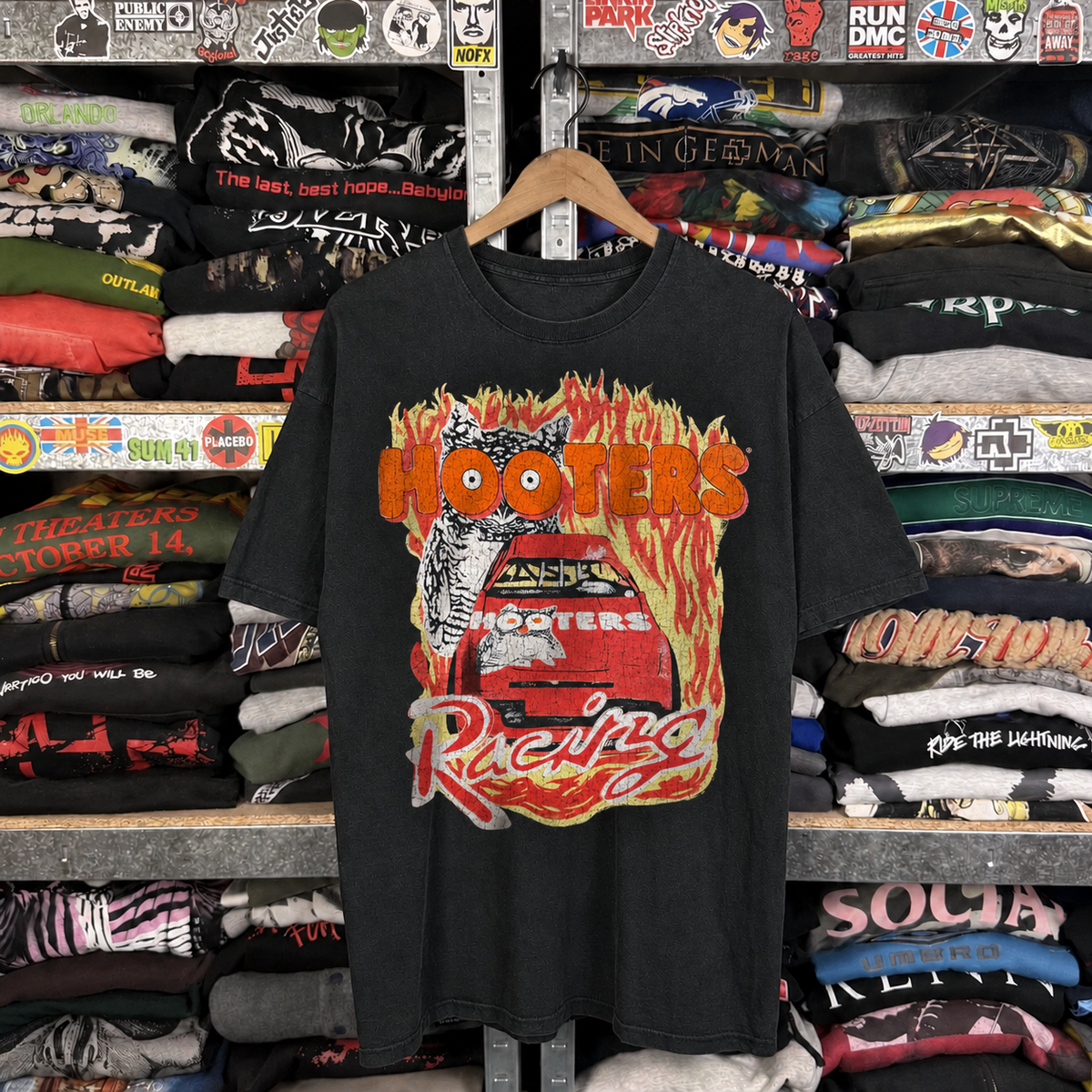 Hooters Racing 90's Washed Black T-Shirt — off-body front on wooden hanger